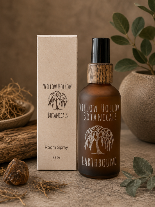 Willow Hollow Botanicals Earthbound luxury room spray featuring vetiver, patchouli, and amber notes in a frosted amber glass bottle with sustainable packaging.
