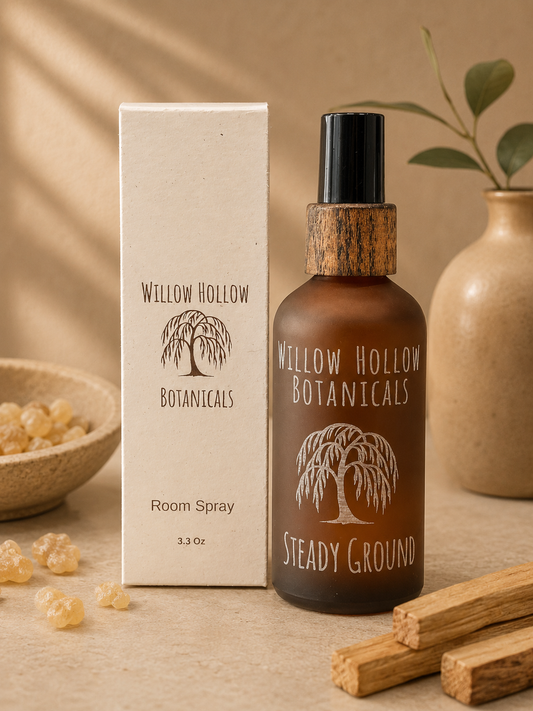 Willow Hollow Botanicals Steady Ground luxury room spray featuring sandalwood, frankincense, and bergamot notes in a frosted amber glass bottle with sustainable packaging.