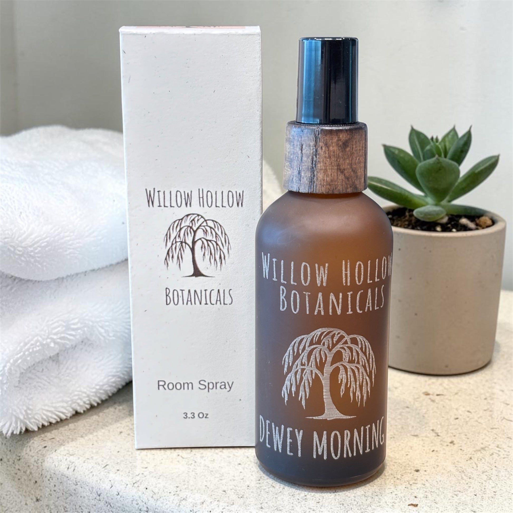 Room spray bottle and packaging with 'Willow Hollow Botanicals' branding on a neutral background.
